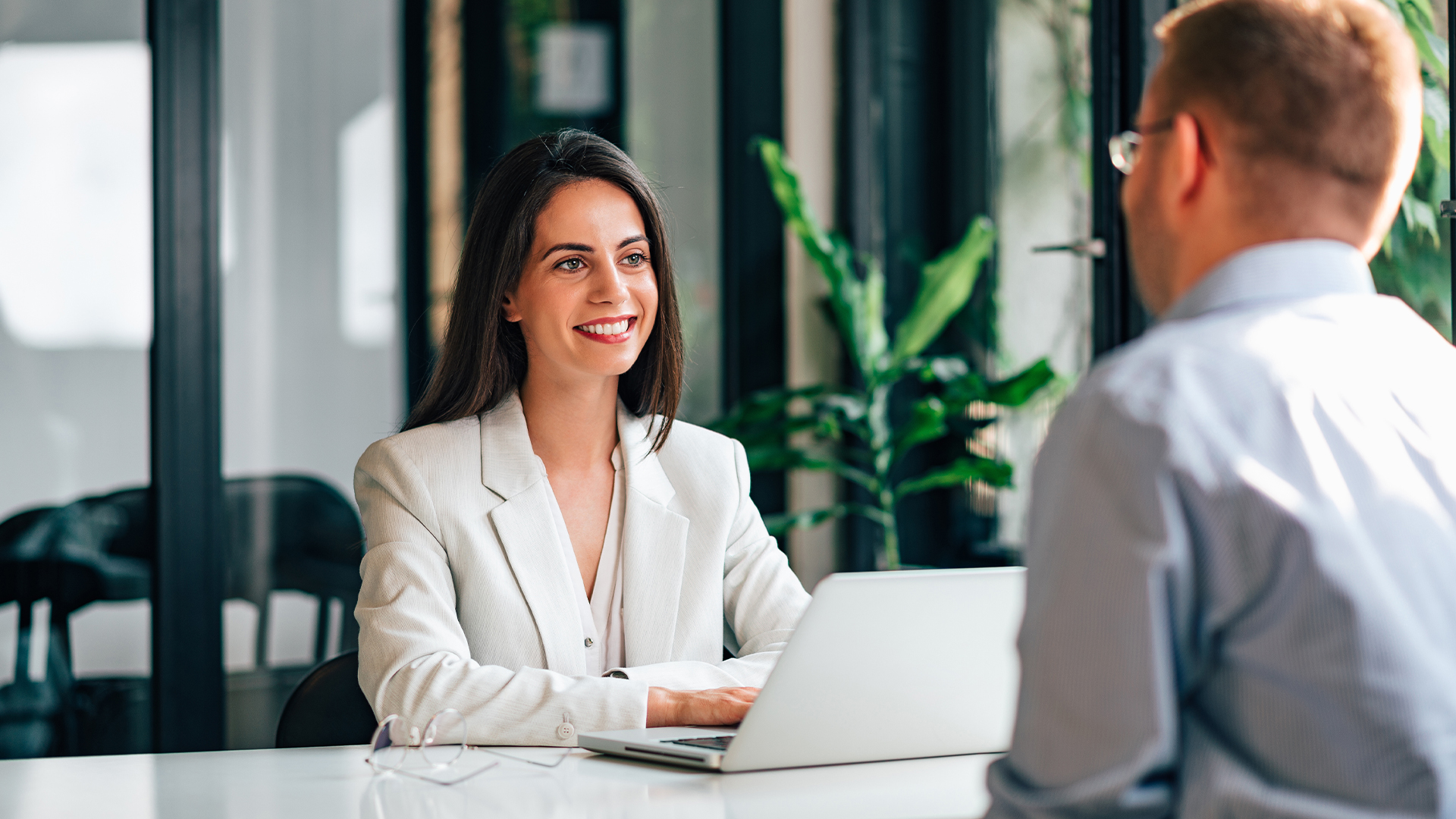 Smiling female financial adviser talking with a customer.