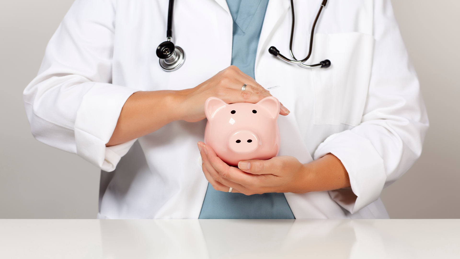 Doctor with Stethoscope Holding Piggy Bank Abstract